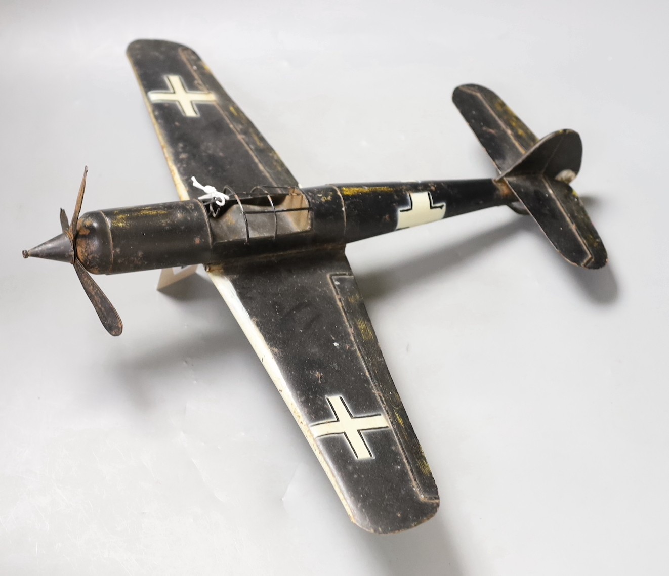 A German tinplate Focke-Wulf model aeroplane, 62cm wingspan, and a tinplate model tractor